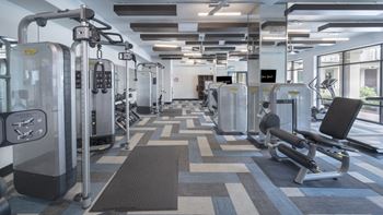 a large fitness room with cardio machines and weights at The Hendrix, Atlanta, GA, 30329